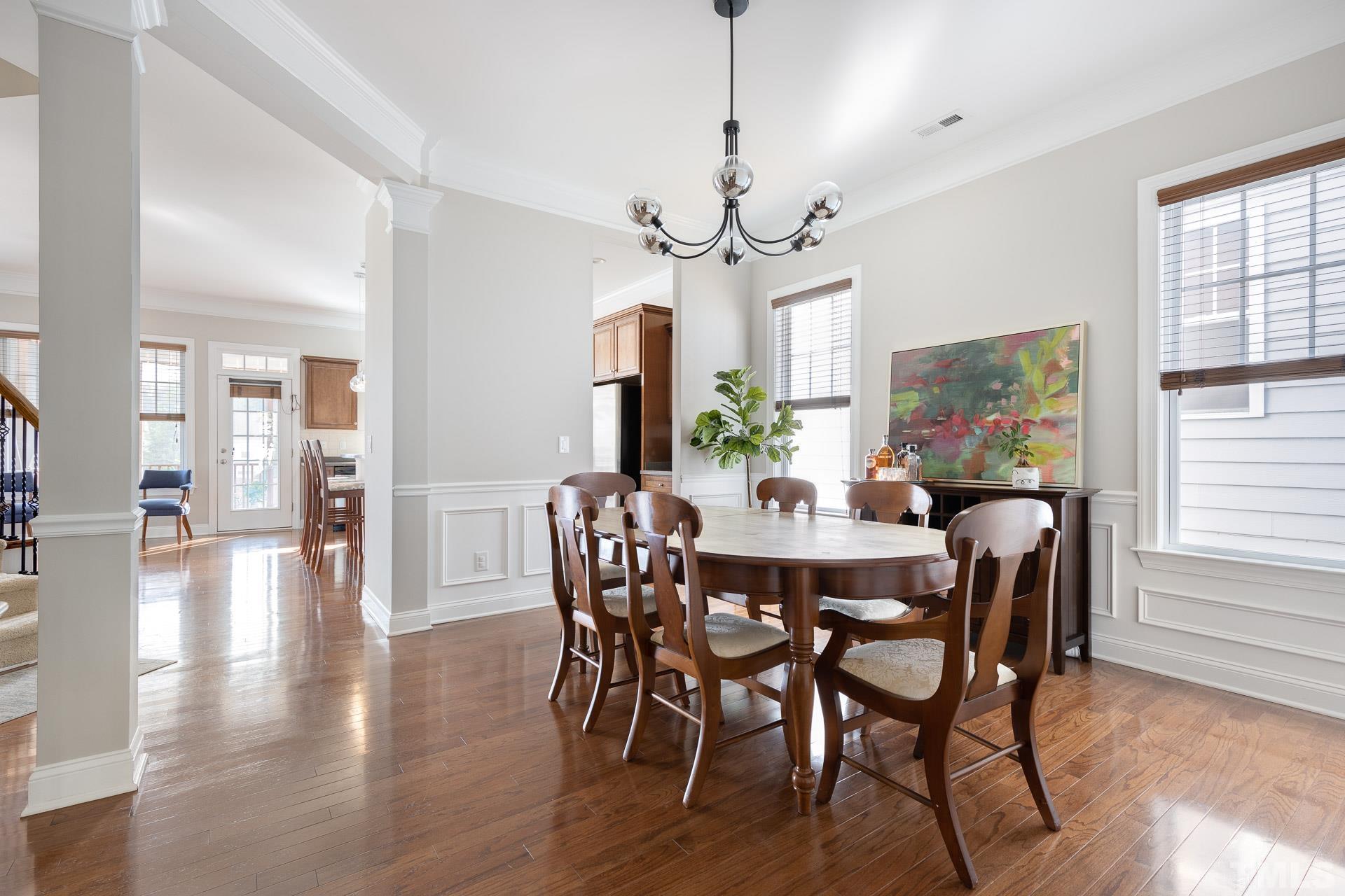 1148 Chapanoke Road Raleigh, NC 27603 - Photo 8 of 47 a view of a dining room with furniture wooden floor and chandelier