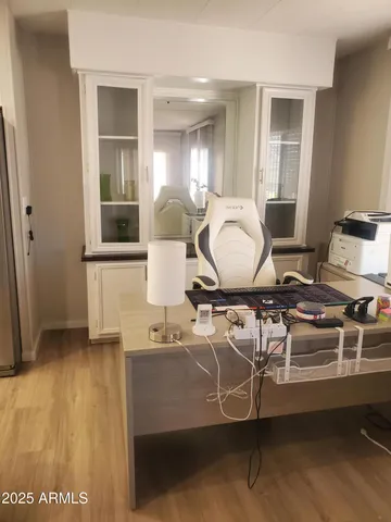 a room with table chairs and wooden floor