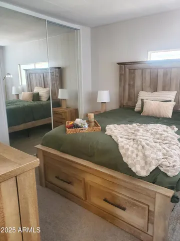 a bedroom with a bed and a couch