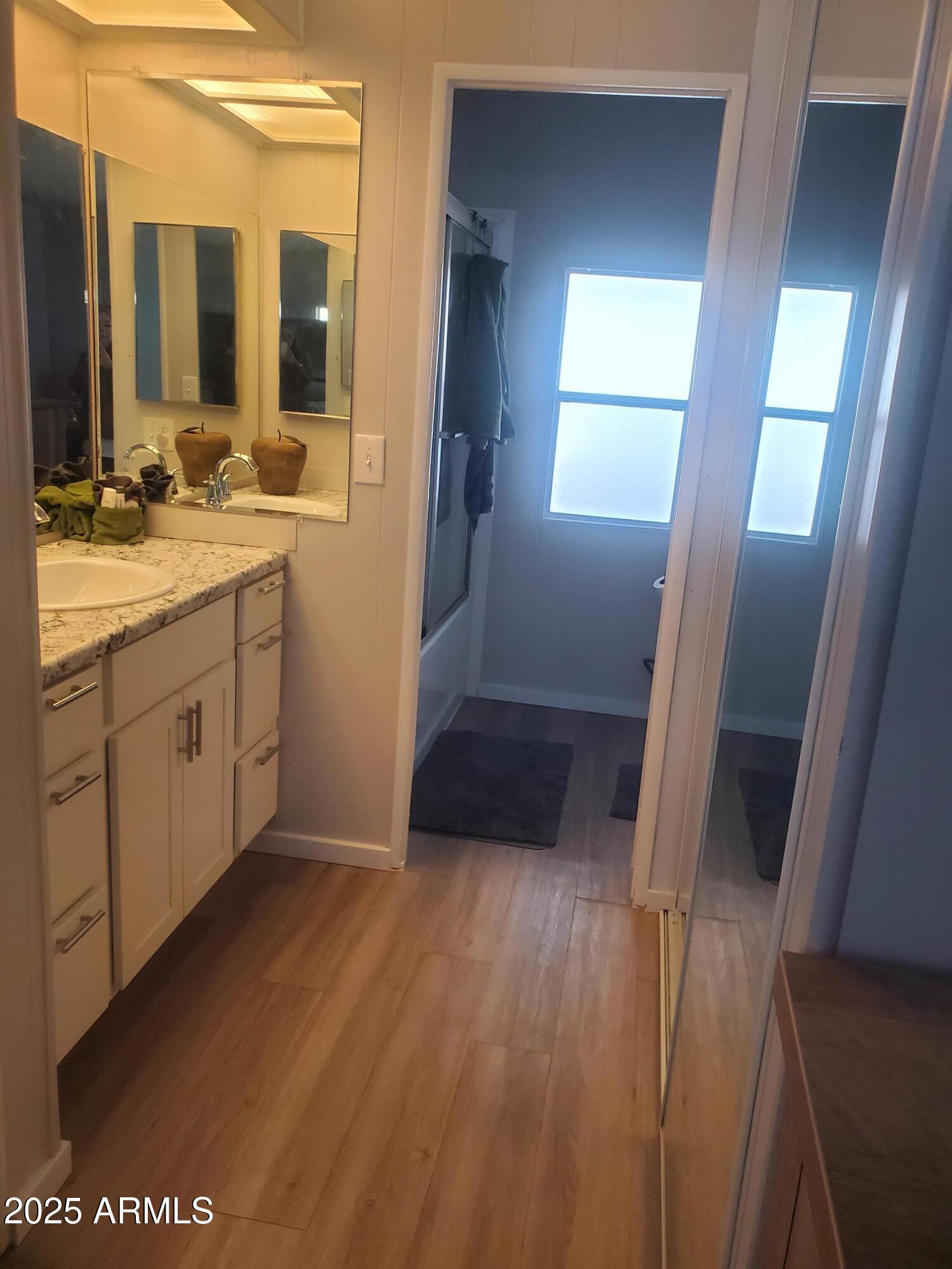3300 East Broadway Road, Unit 128 Mesa, AZ 85204 - Photo 20 of 32 a bathroom with a sink a mirror and a shower