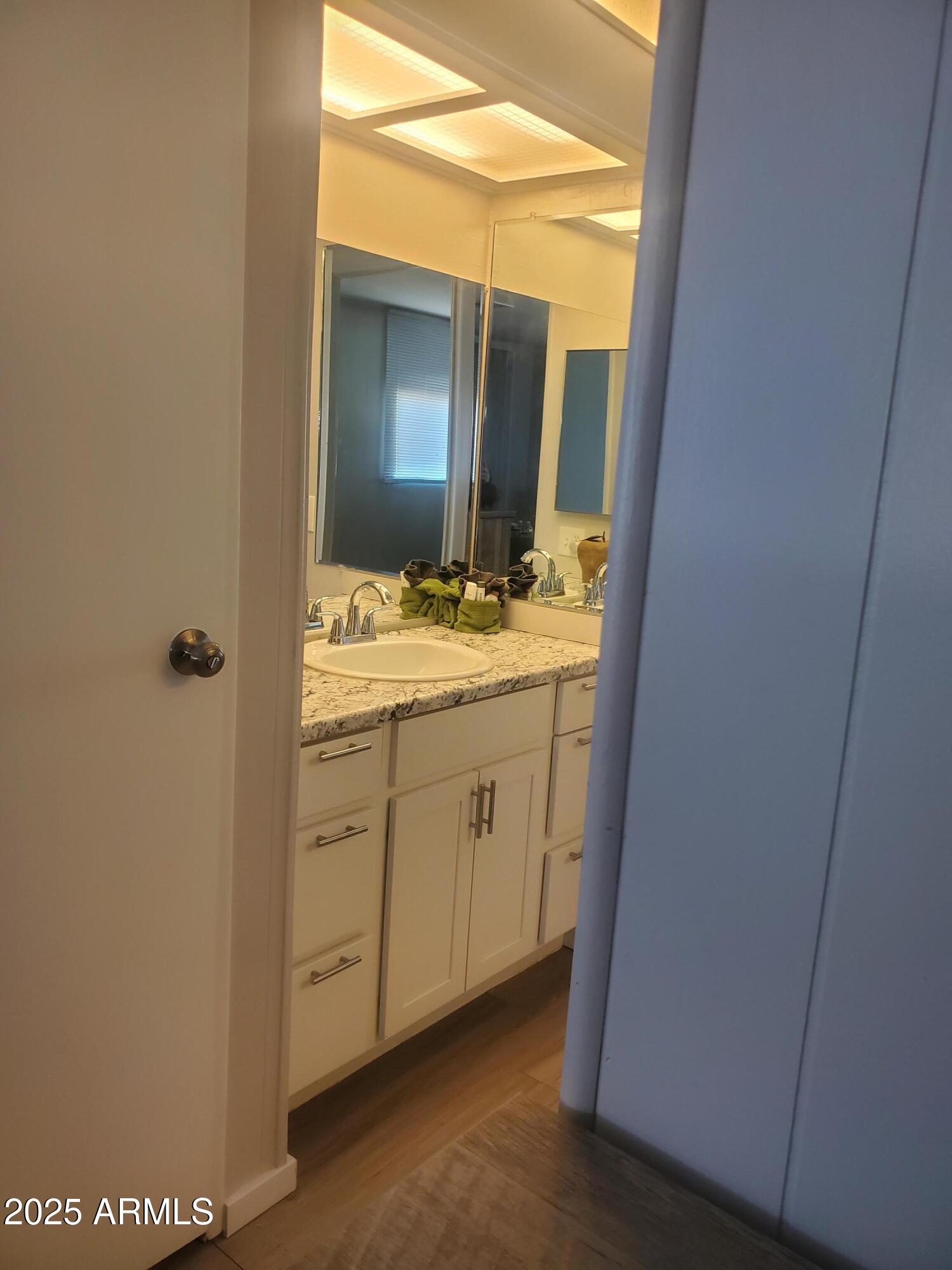 3300 East Broadway Road, Unit 128 Mesa, AZ 85204 - Photo 21 of 32 a spacious bathroom with a double vanity sink and mirror