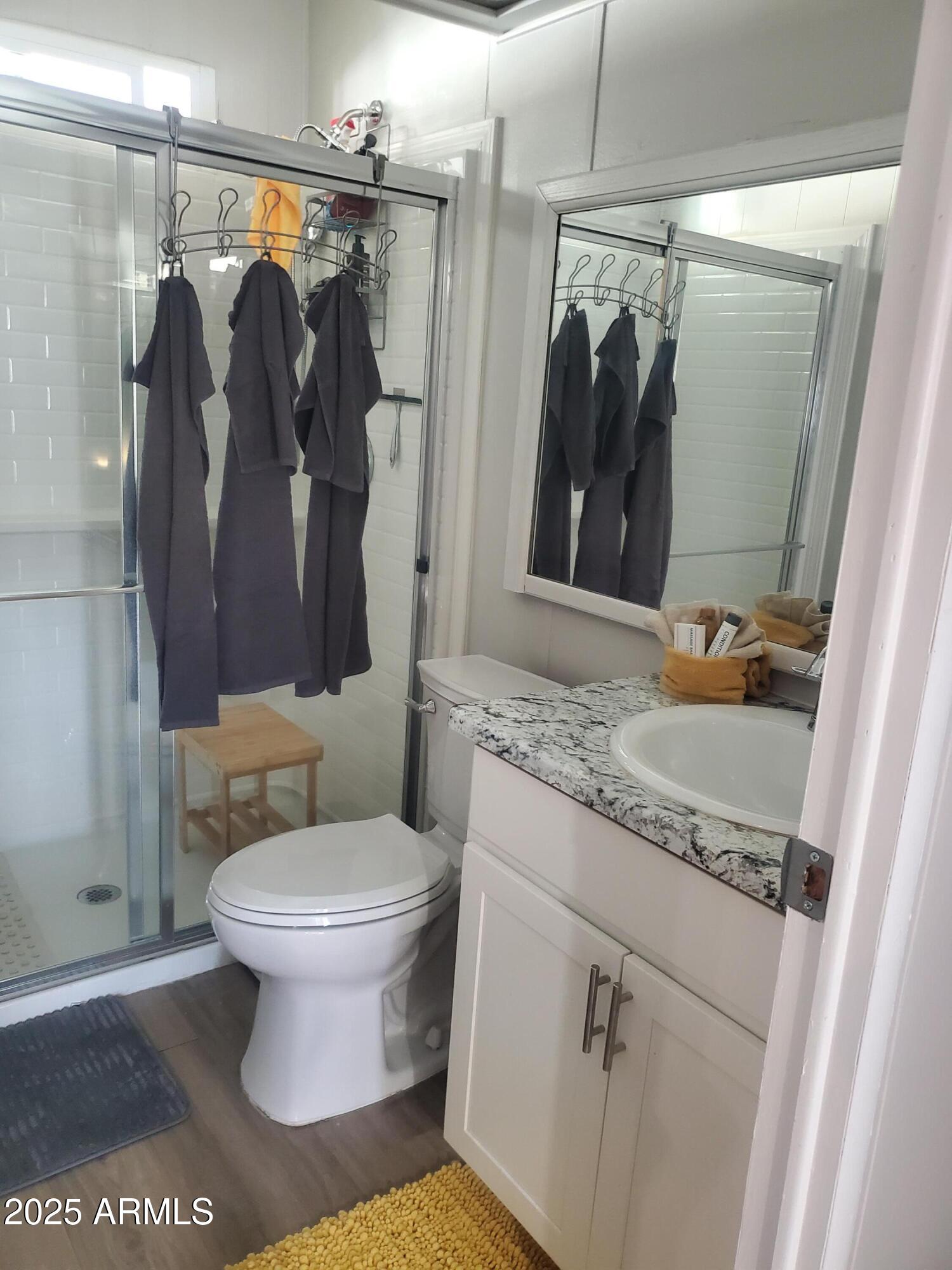 3300 East Broadway Road, Unit 128 Mesa, AZ 85204 - Photo 23 of 32 a bathroom with a granite countertop sink toilet and shower