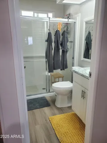 a bathroom with a toilet and a shower