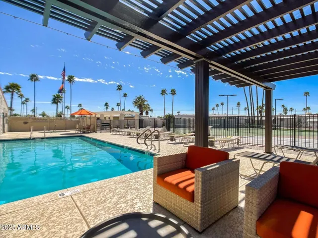 a view of a swimming pool with a lounge chairs