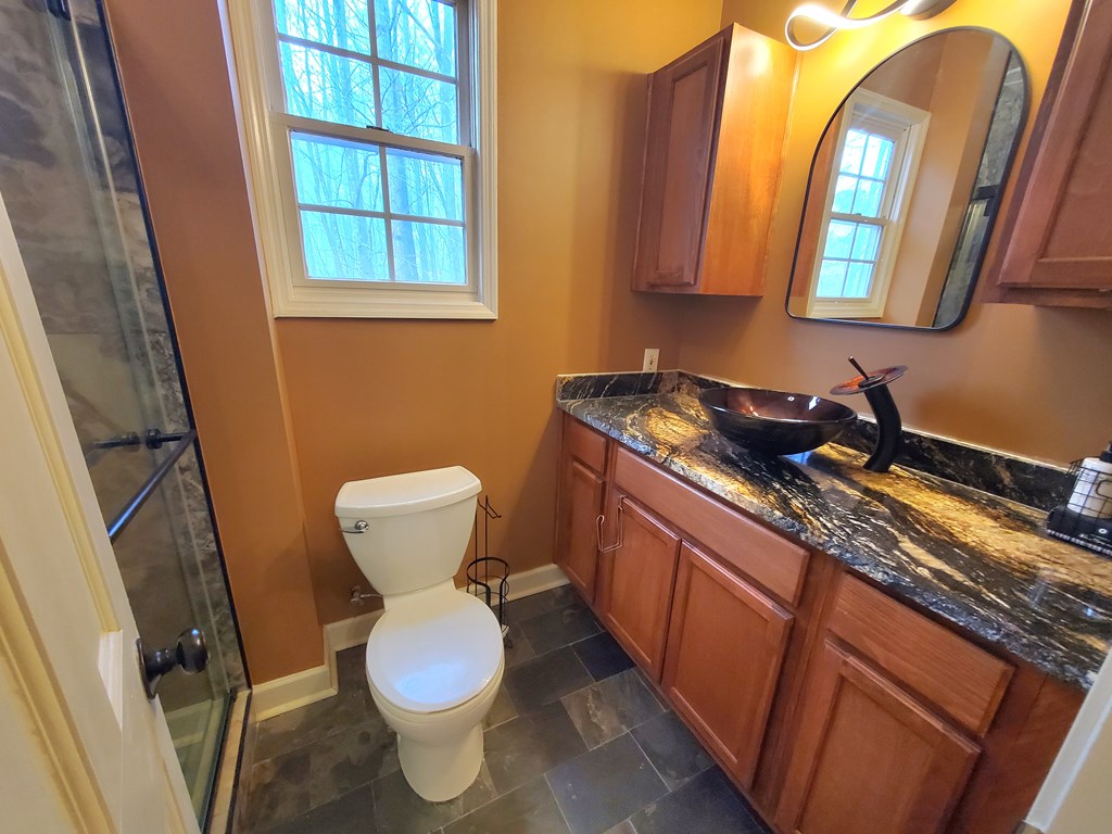 192 Mill Pond Court Jasper, GA 30143 - Photo 13 of 29 a bathroom with a toilet sink and mirror