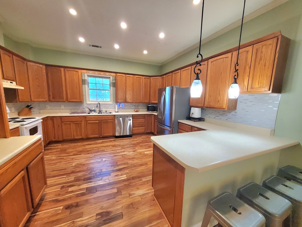 192 Mill Pond Court Jasper, GA 30143 - Photo 3 of 29 a kitchen with stainless steel appliances granite countertop a sink refrigerator and cabinets
