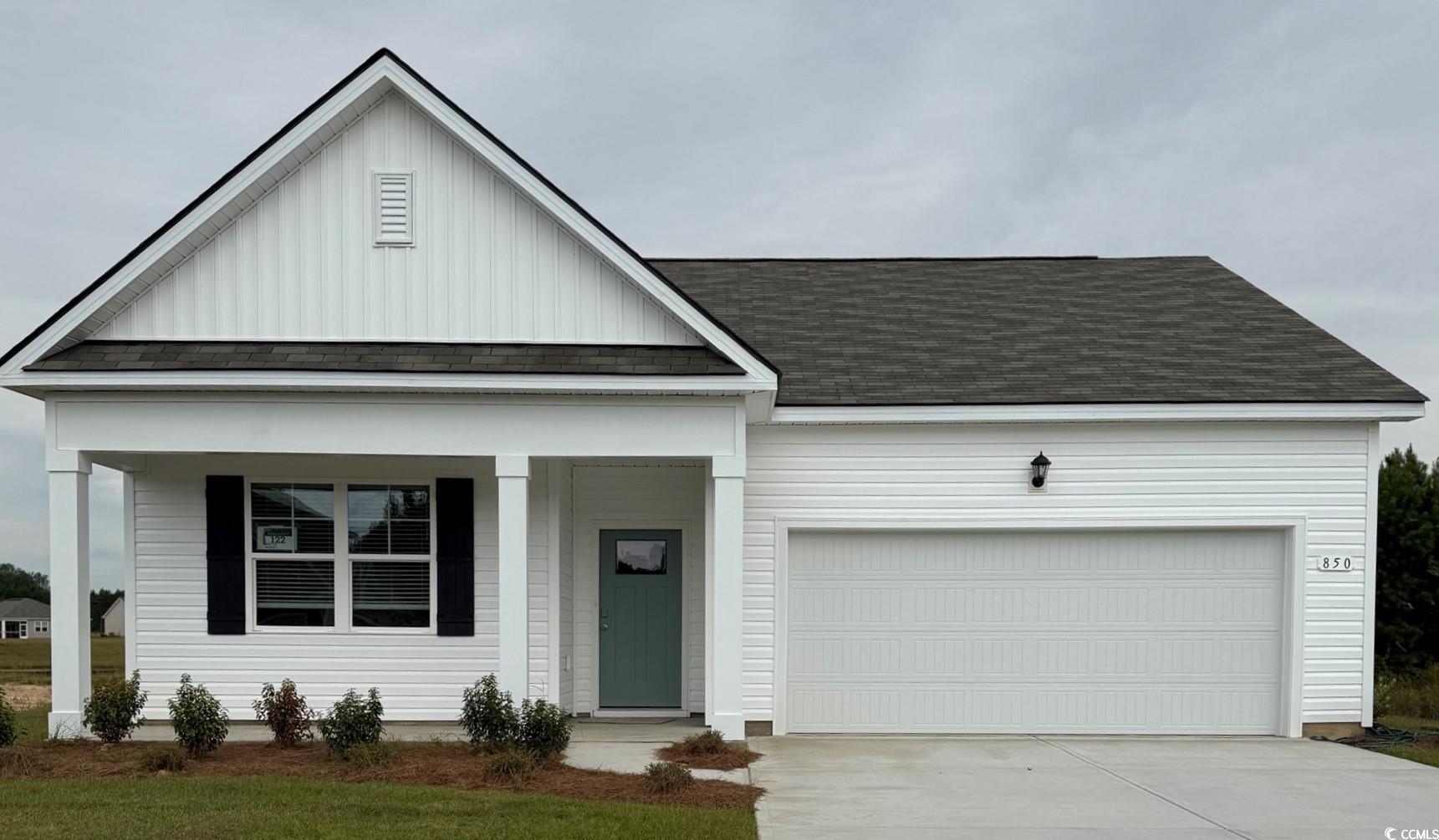 850 Farmers Passage Loop Loris, SC 29569 - Photo 1 of 28 View of front facade featuring board and batten siding, a porch, driveway, roof with shingles, and an attached garage