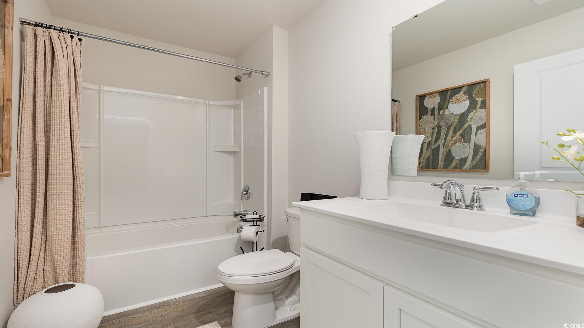 850 Farmers Passage Loop Loris, SC 29569 - Photo 21 of 28 Full bath with toilet, wood finished floors, shower / tub combo, and vanity