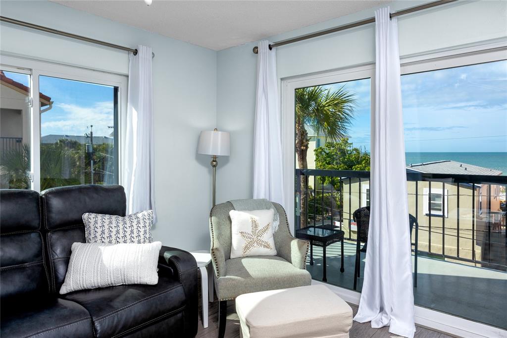 1300 Gulf Boulevard, Unit 301 Indian Rocks Beach, FL 33785 - Photo 11 of 46 a living room with furniture and a window