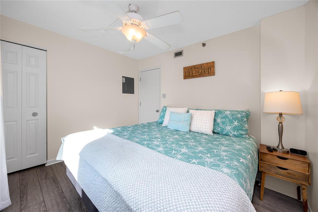 1300 Gulf Boulevard, Unit 301 Indian Rocks Beach, FL 33785 - Photo 21 of 46 a bedroom with a bed and a lamp on table