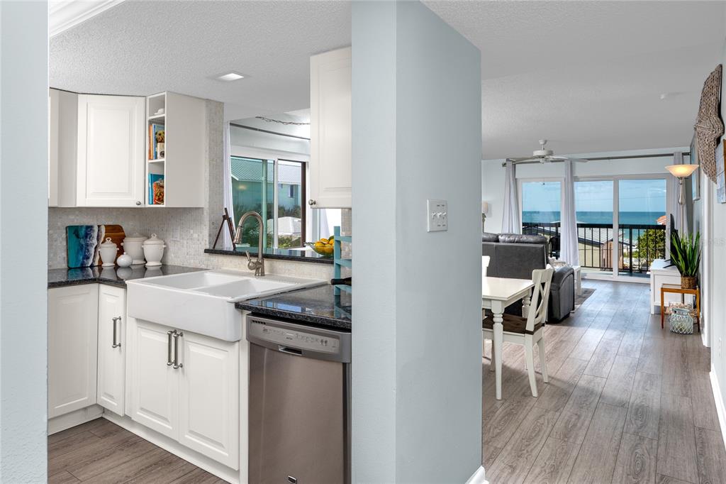 1300 Gulf Boulevard, Unit 301 Indian Rocks Beach, FL 33785 - Photo 3 of 46 a kitchen with a sink window and cabinets