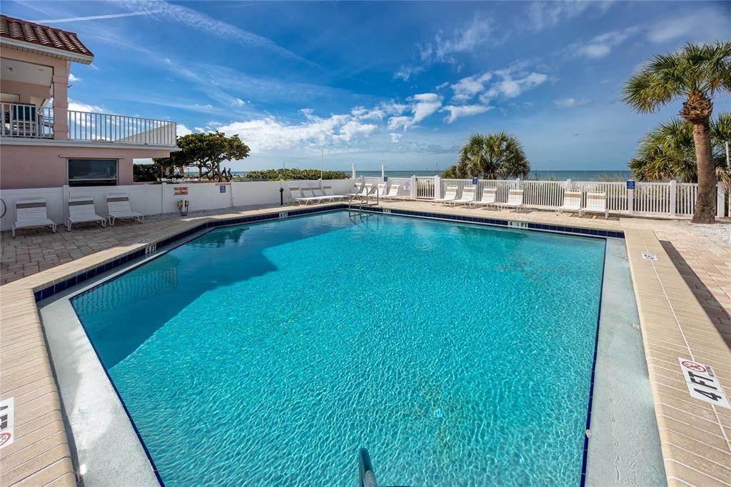 1300 Gulf Boulevard, Unit 301 Indian Rocks Beach, FL 33785 - Photo 31 of 46 a view of a swimming pool with an outdoor seating