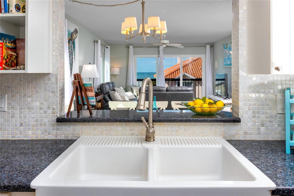 1300 Gulf Boulevard, Unit 301 Indian Rocks Beach, FL 33785 - Photo 4 of 46 a view of living room with kitchen and chandelier