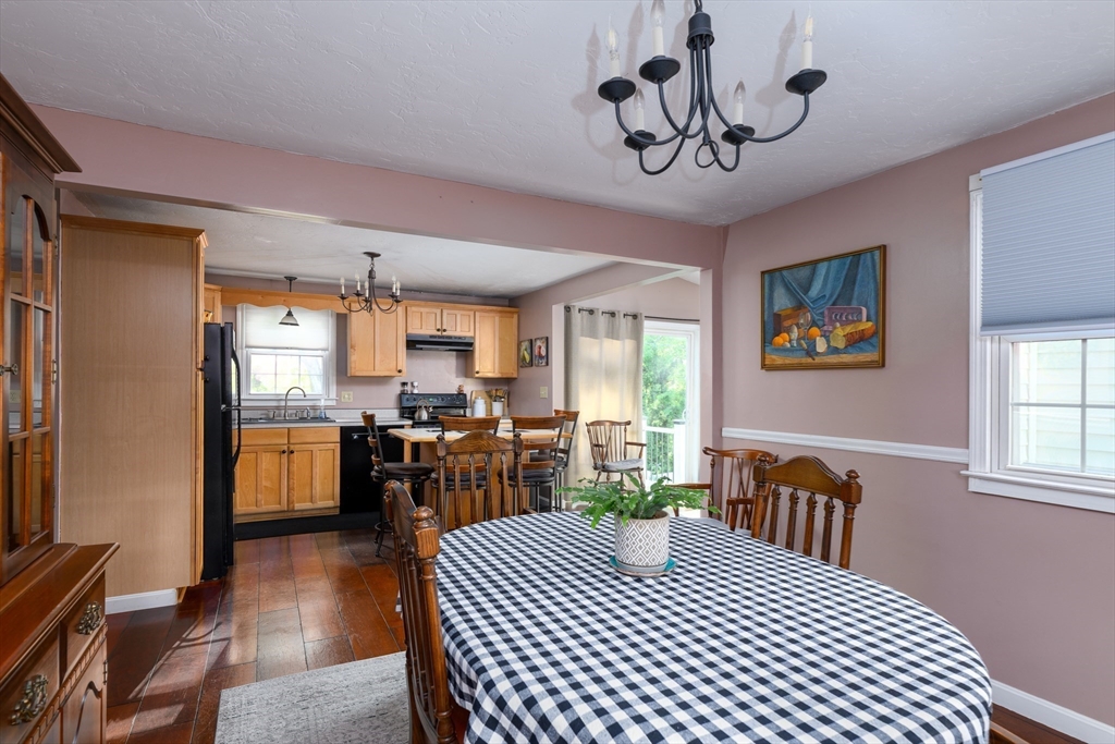 32 Westview Road Worcester, MA 01602 - Photo 5 of 18 a kitchen with a refrigerator a stove a dining table and chairs with wooden floor