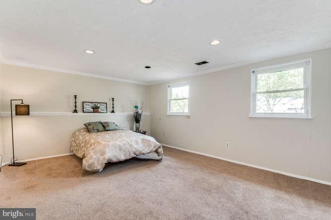15425 Wembrough Street Silver Spring, MD 20905 - Photo 22 of 25 a spacious bedroom with a bed and a window