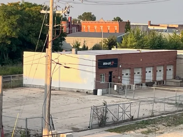 a view of a brick house with large windows