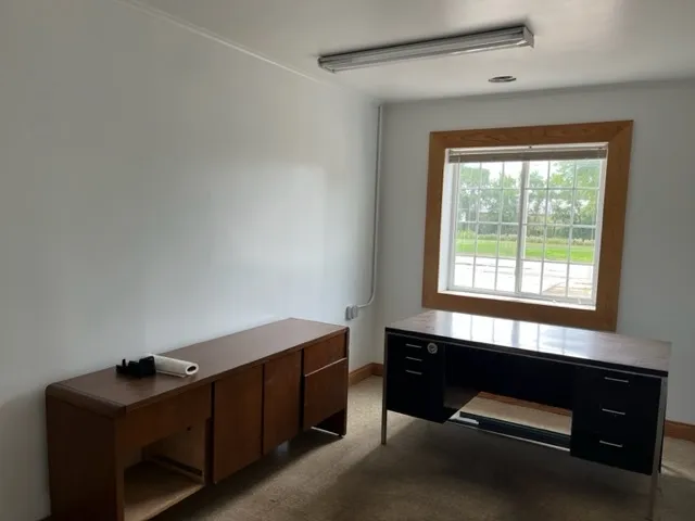 a room with a window and a dresser