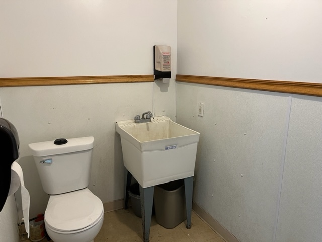 603 2nd Avenue Rochelle, IL 61068 - Photo 7 of 15 a bathroom with a sink a toilet and vanity