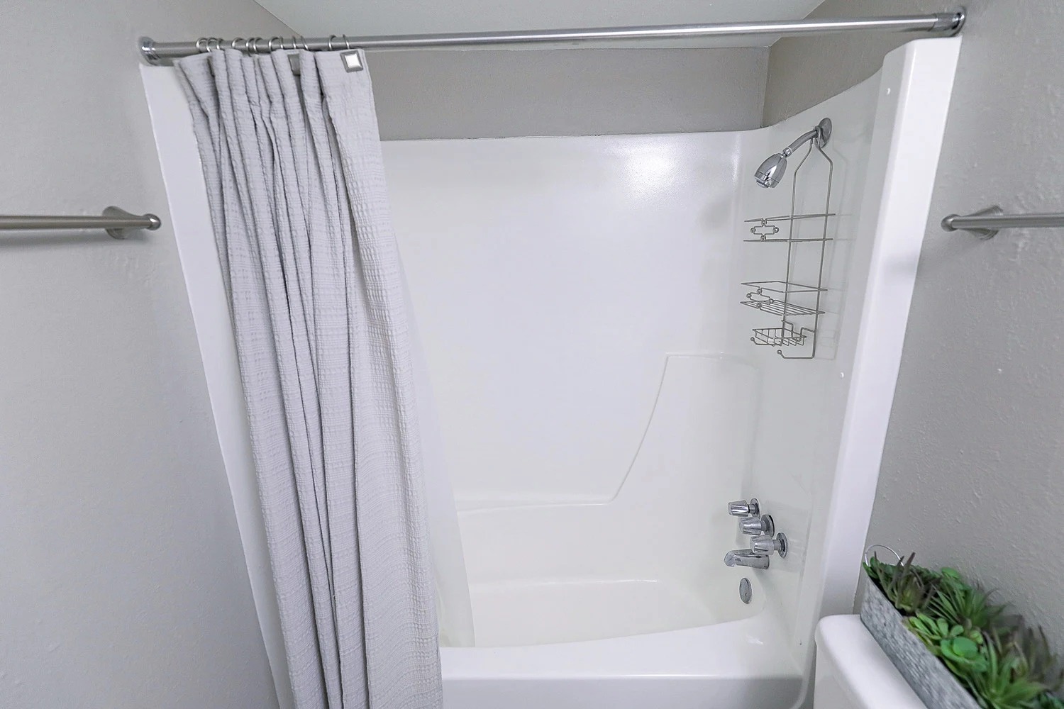 8100 North Mopac Expressway, Unit 5223 Austin, TX 78759 - Photo 19 of 28 Bathroom with shower / bath combo with shower curtain and a textured wall