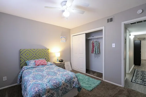 a bedroom with a bed and a chandelier