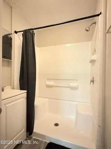 a bathroom with a shower and a toilet