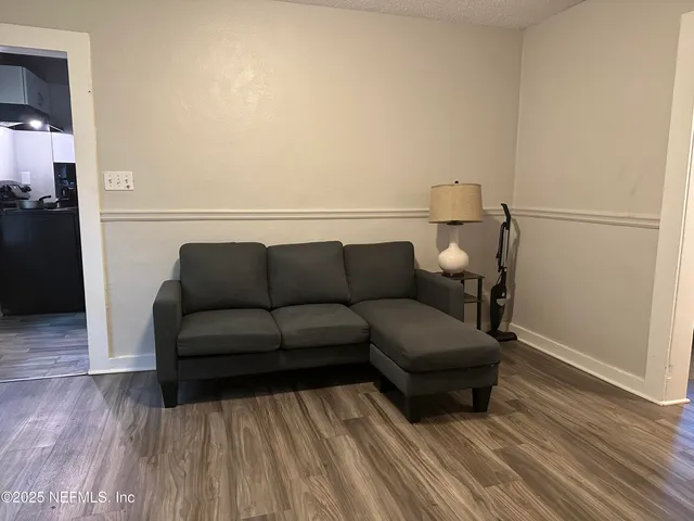 a living room with a couch and a wooden floor