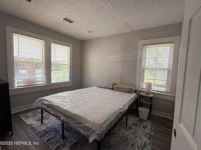 a bedroom that has a bed and a table in it