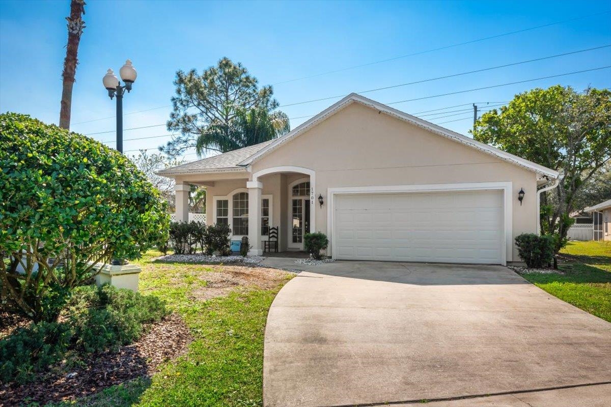 1701 Keswick Road St. Augustine, FL 32084 - Photo 1 of 57 a view of a white house with a small yard and potted plants