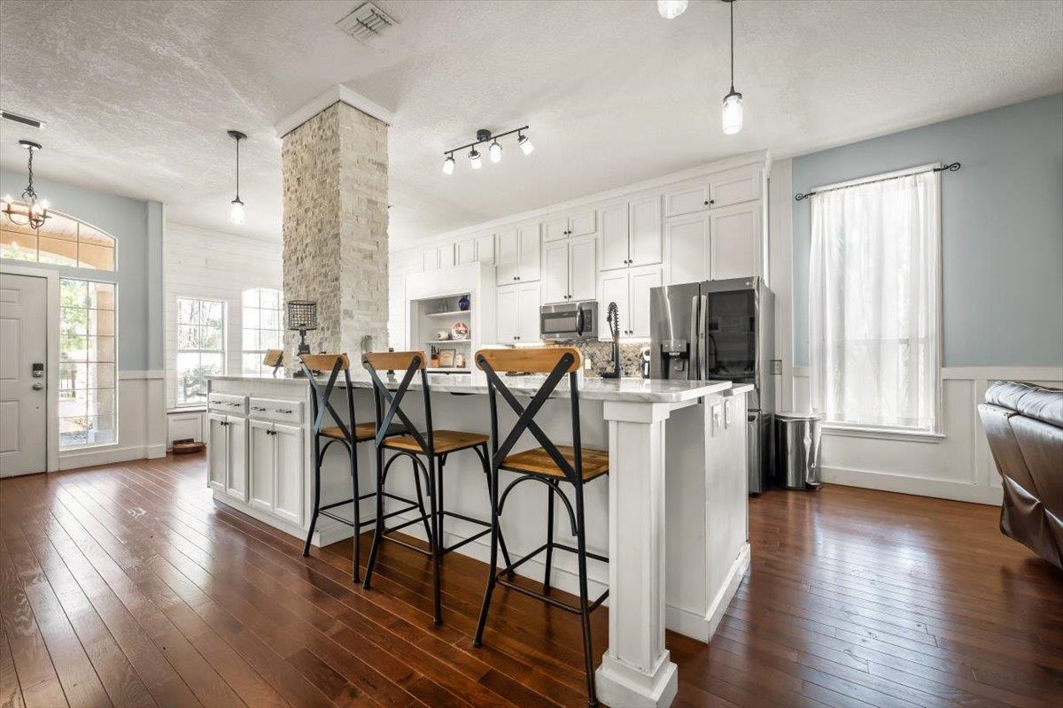 1701 Keswick Road St. Augustine, FL 32084 - Photo 15 of 57 a kitchen with stainless steel appliances a table chairs refrigerator and microwave