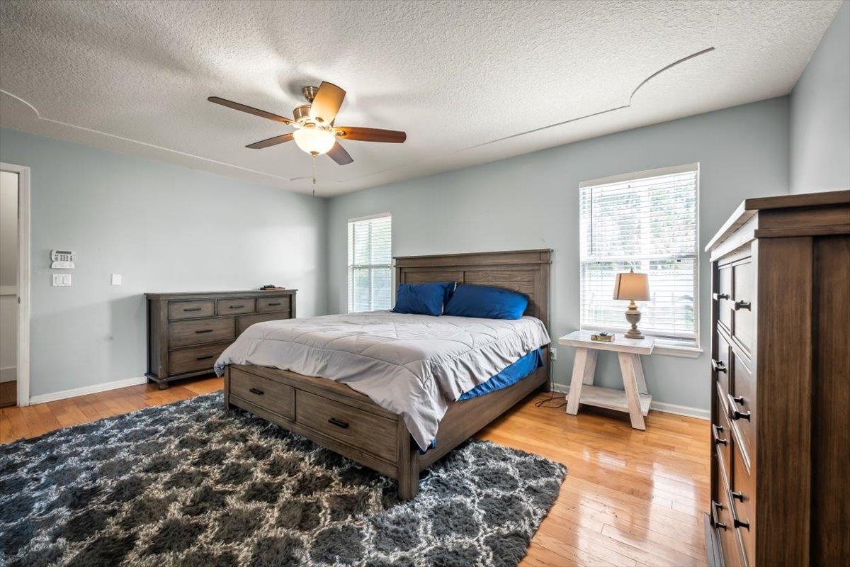1701 Keswick Road St. Augustine, FL 32084 - Photo 17 of 57 a bedroom with a bed and a chandelier