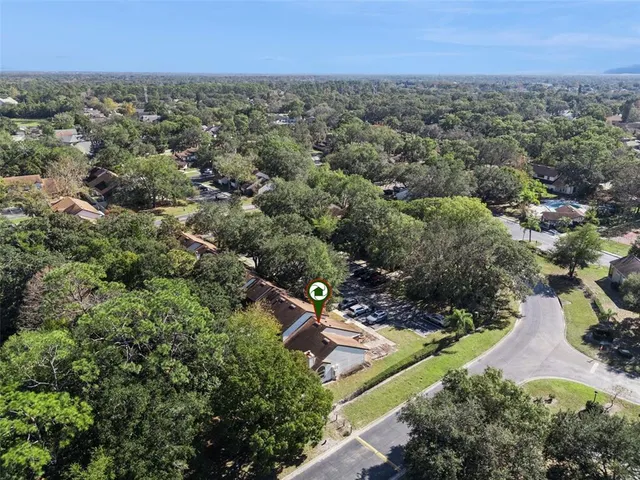 an aerial view of a house with a yard