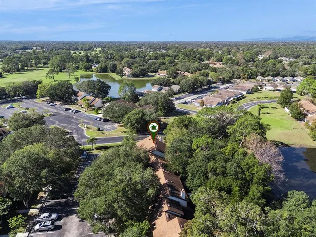an aerial view of a house with a yard