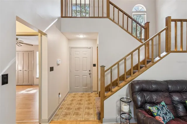 a view of a livingroom with wooden floor and a ceiling fan