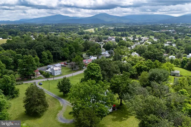 a front view of a house with a yard table and chairs