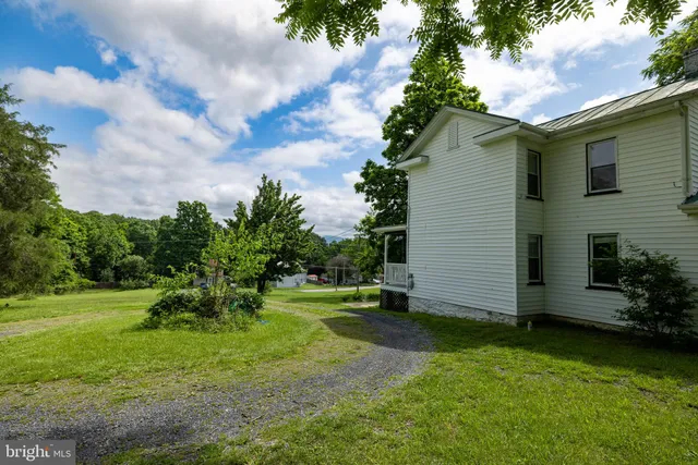 a view of a livingroom with wooden floor and a window