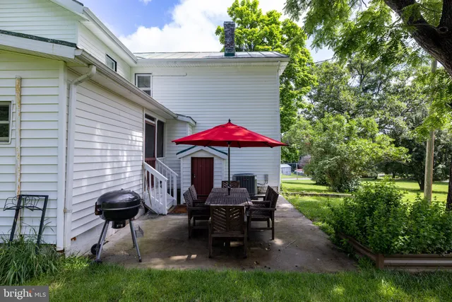 a bedroom with a bed a table and chair