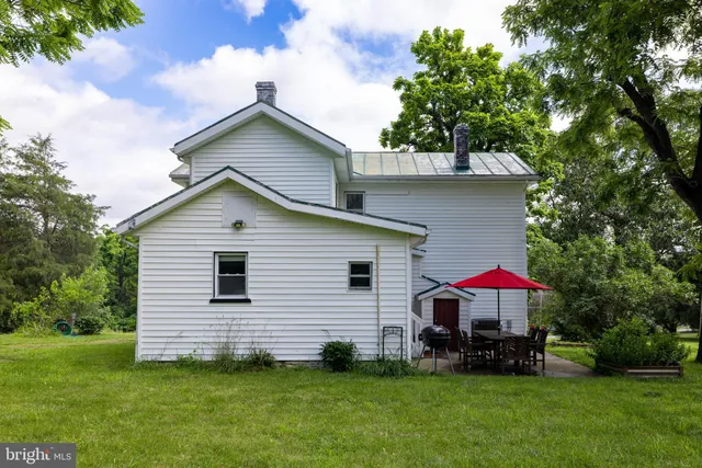 a view of an entryway with wooden floor and staircase