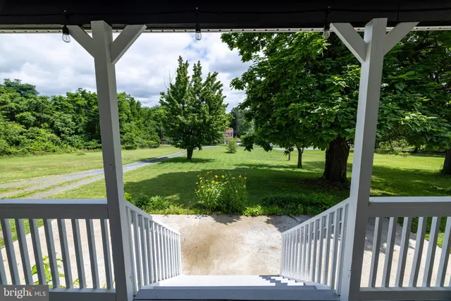 a large bed sitting in a bedroom next to a window