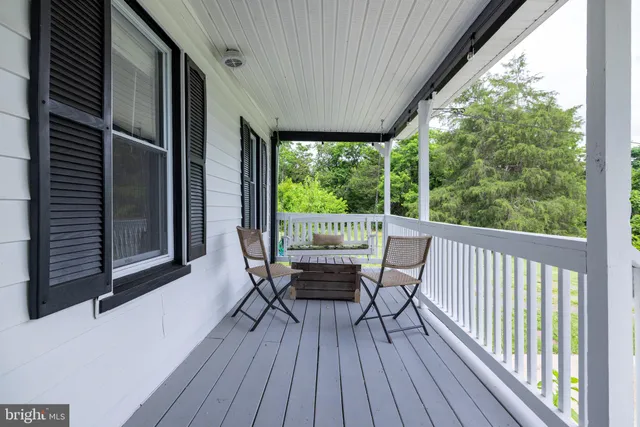 a view of a kitchen with wooden floor and a window