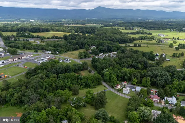 an aerial view of residential house with outdoor space and trees around