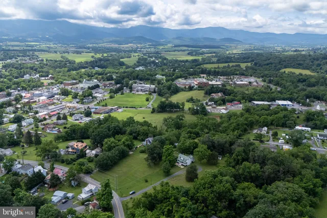 a view of a backyard with furniture and a fire pit