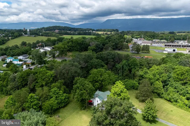 a view of a house with a yard and sitting area