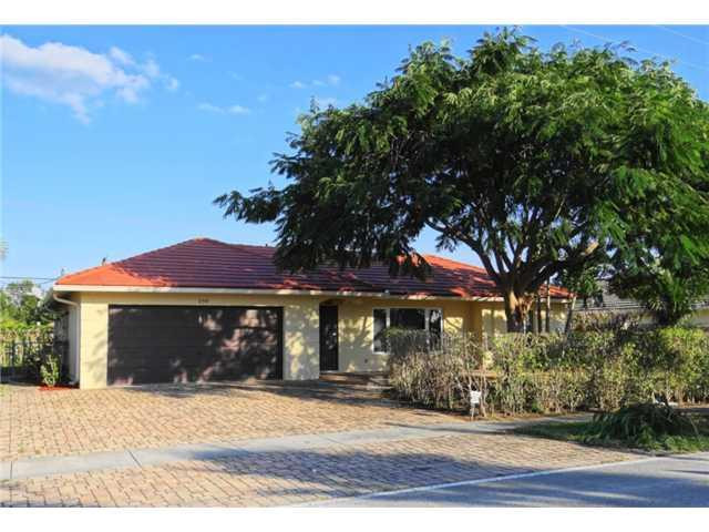 298 Southwest 9th Avenue Boca Raton, FL 33486 - Photo 1 of 10 a front view of a house with a garden