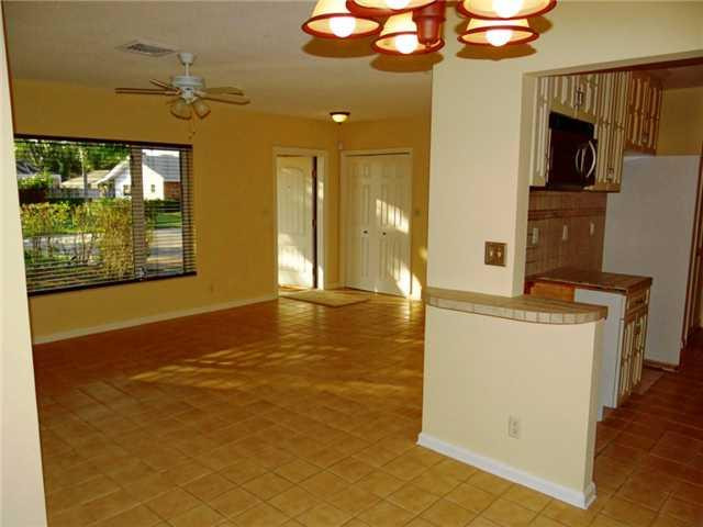 298 Southwest 9th Avenue Boca Raton, FL 33486 - Photo 2 of 10 a view of a kitchen with a fridge and wooden floor