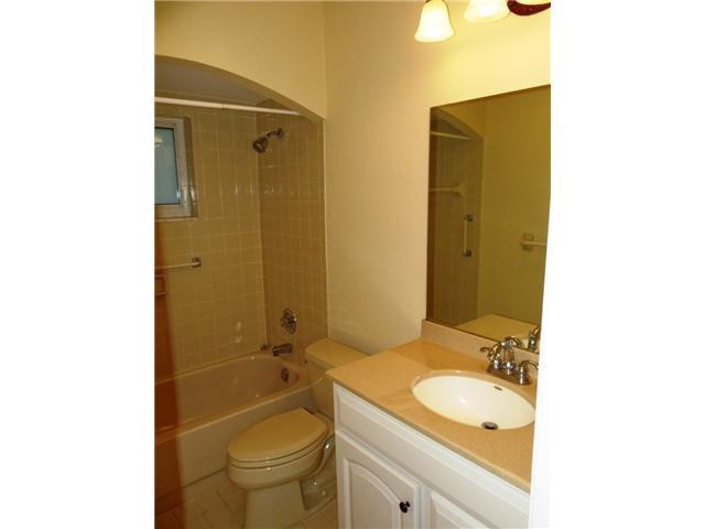 298 Southwest 9th Avenue Boca Raton, FL 33486 - Photo 7 of 10 a bathroom with a granite countertop sink toilet and shower