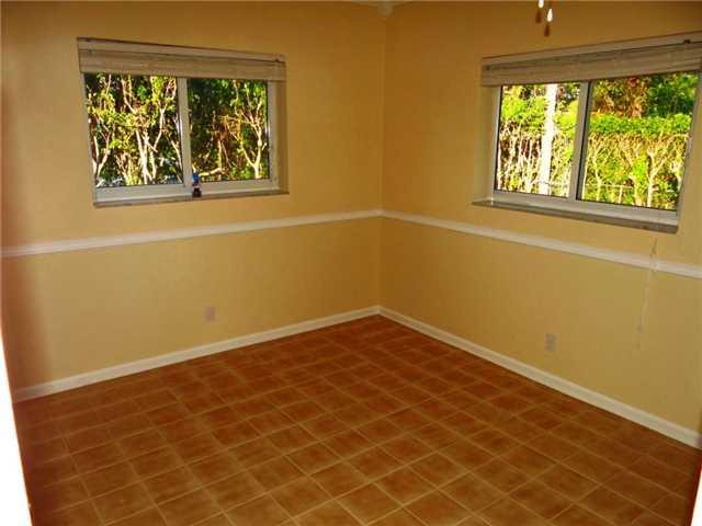 298 Southwest 9th Avenue Boca Raton, FL 33486 - Photo 8 of 10 a view of a small space with wooden floor and a window