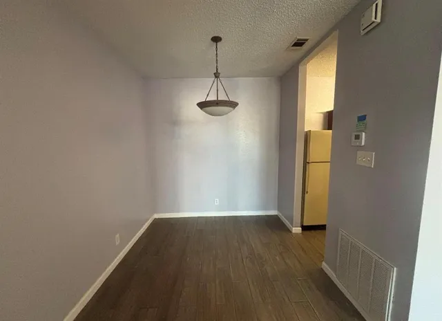 a view of a room with wooden floor and windows