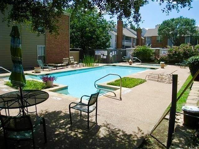 2105 Count Fleet Drive, Unit 212 Arlington, TX 76011 - Photo 14 of 14 a view of swimming pool with outdoor seating and plants