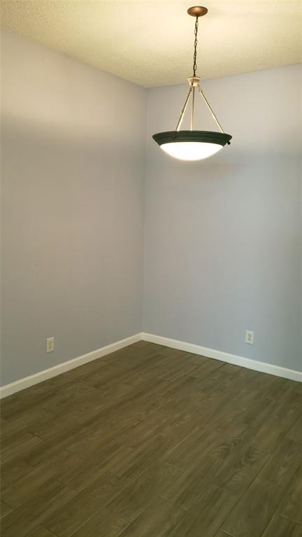 2105 Count Fleet Drive, Unit 212 Arlington, TX 76011 - Photo 10 of 14 a view of a room with wooden floor and fan