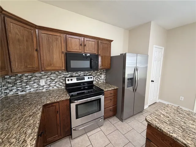 a view of a room with wooden floor and fan